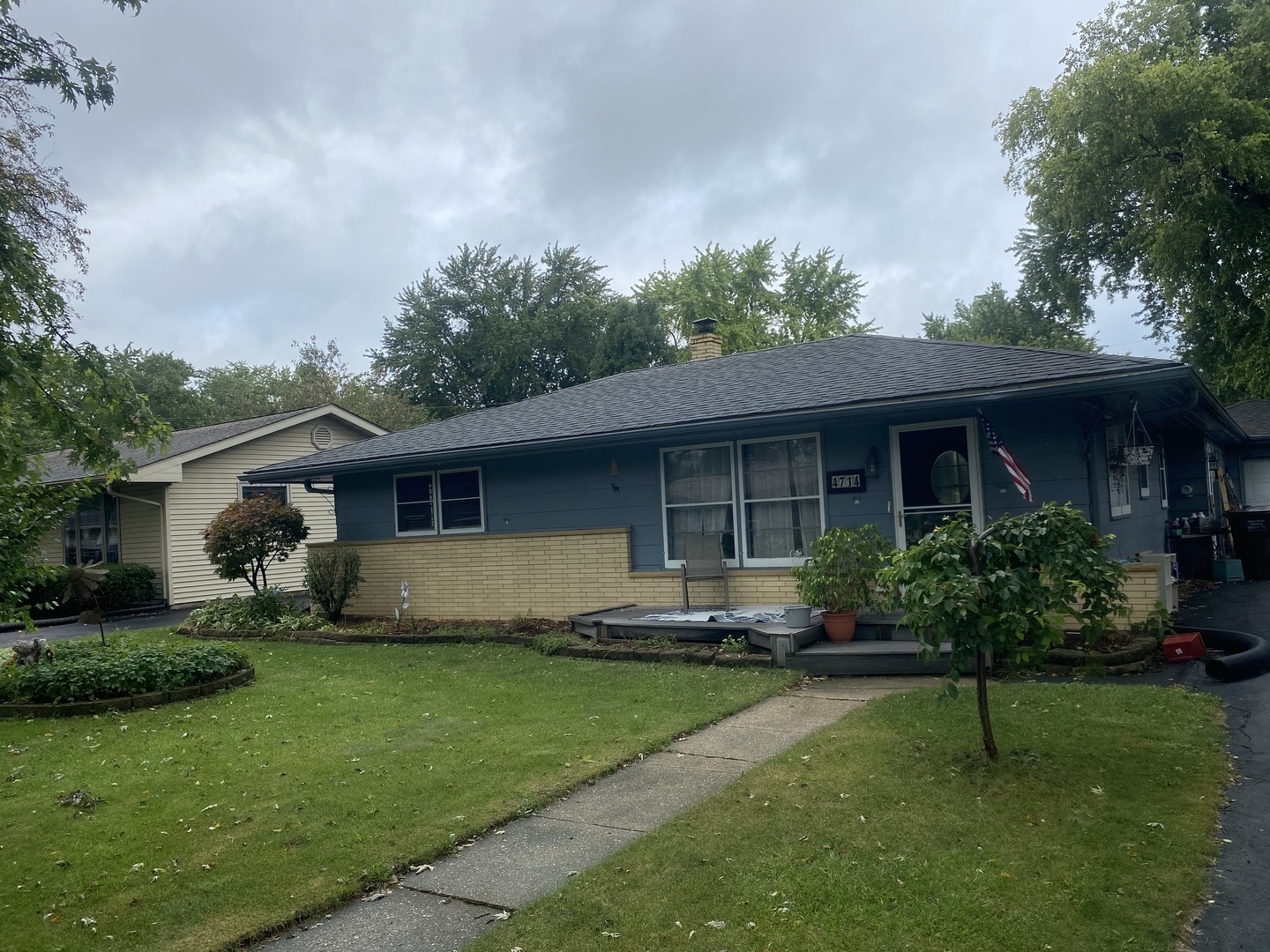 a front view of a house with a yard and porch