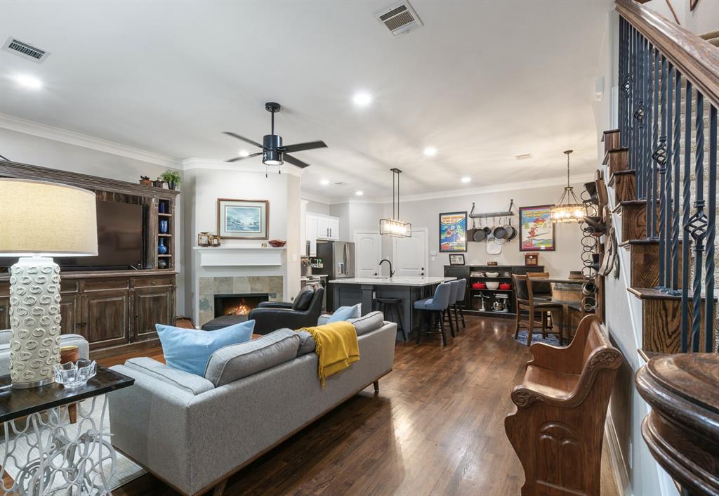 a living room with furniture kitchen view and a fireplace