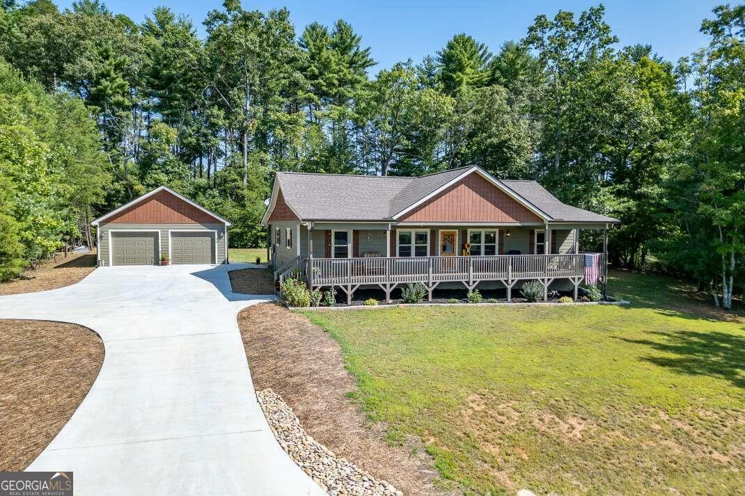 a front view of house with yard outdoor seating and green space