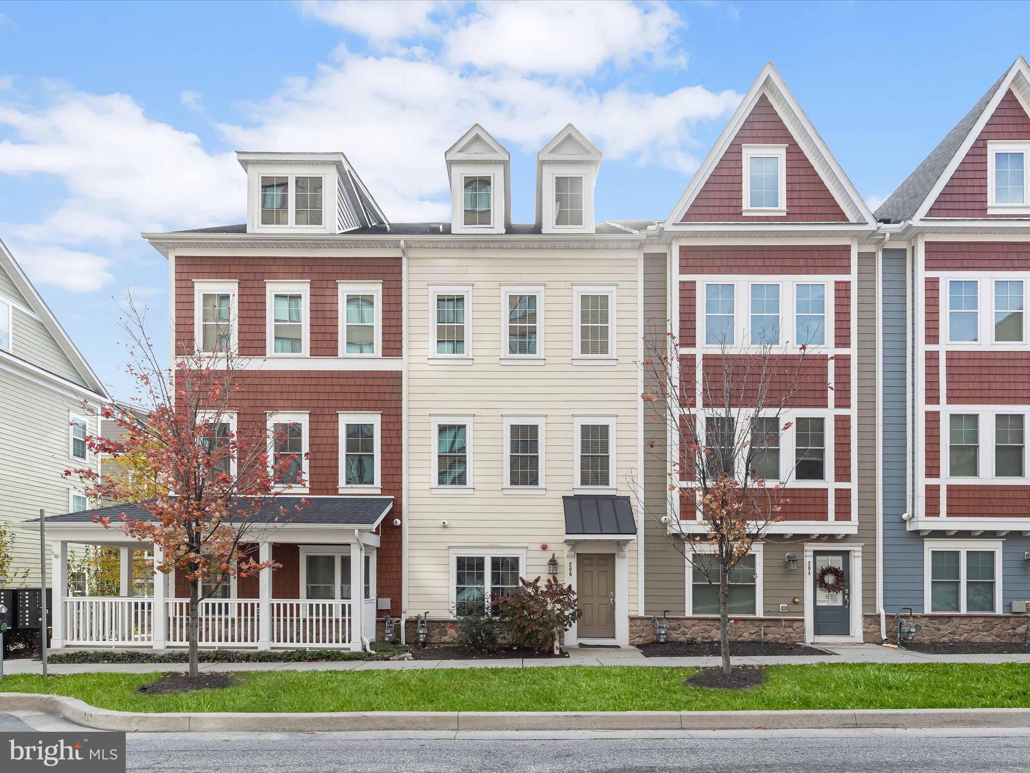 a front view of a residential apartment building with a yard