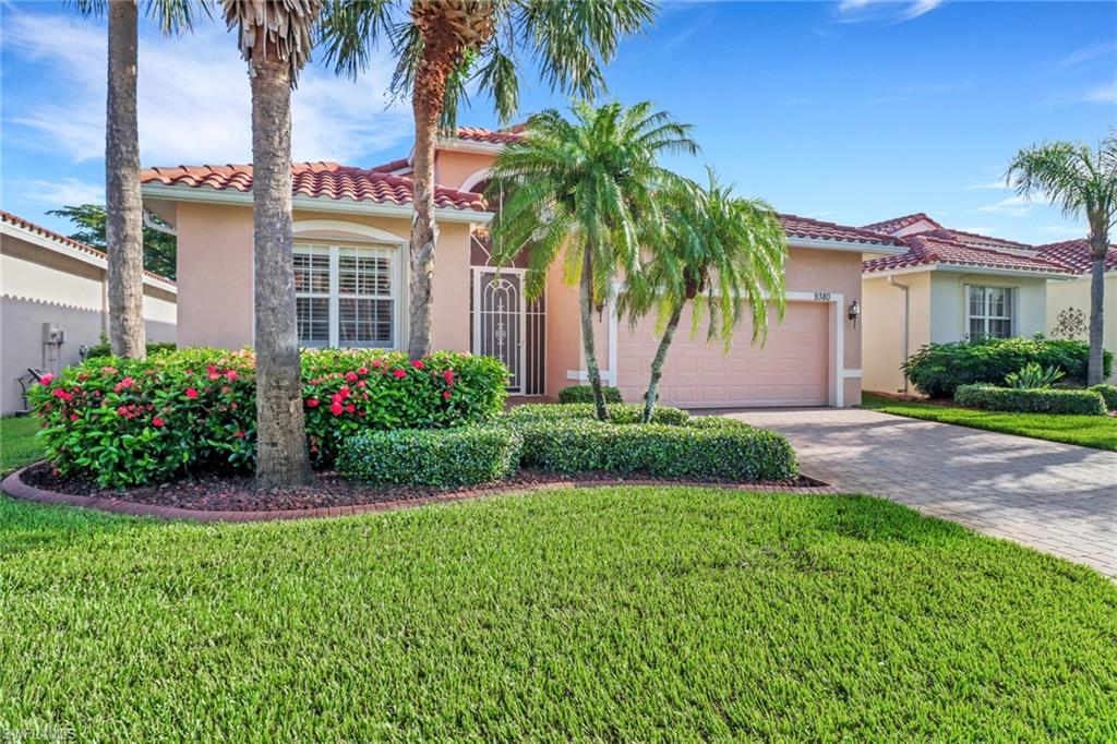 Mediterranean / spanish-style house with a garage and a front lawn