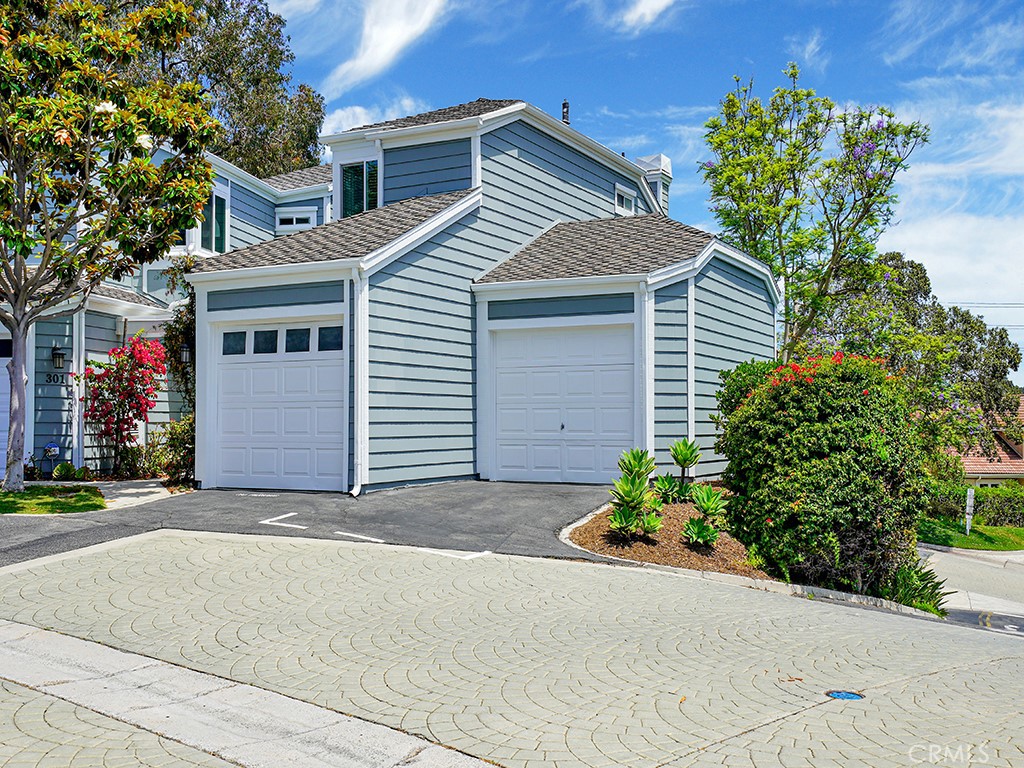 a front view of a house with a yard and a garage