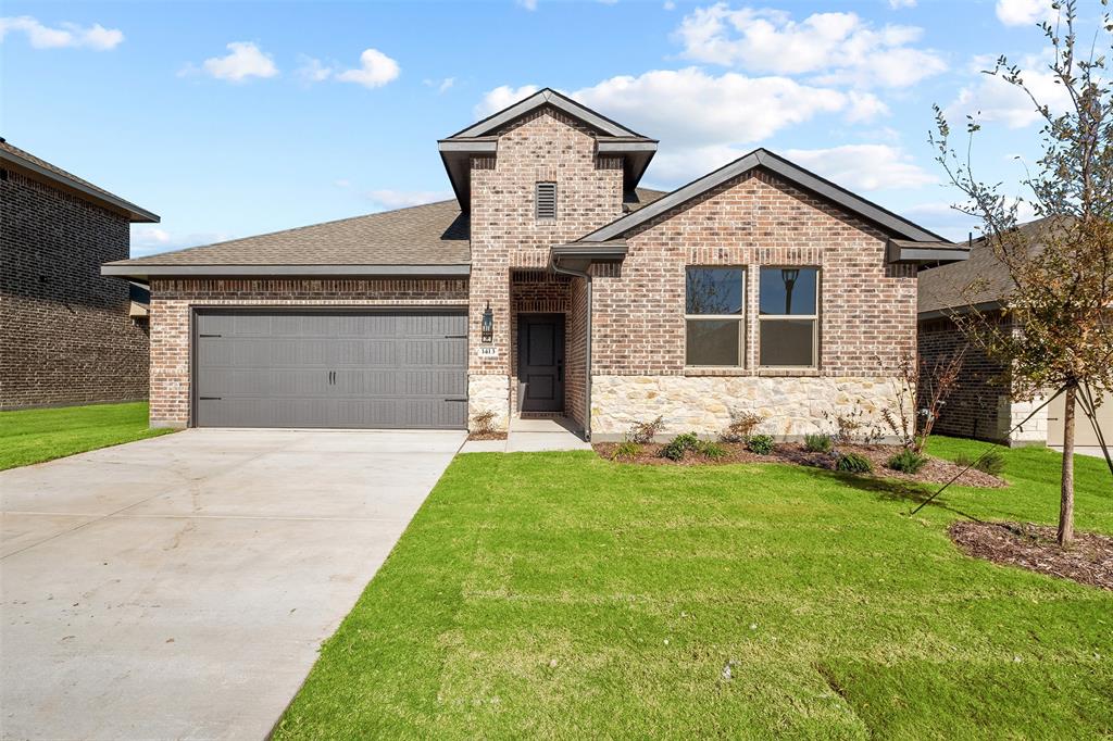 a front view of a house with a yard and garage