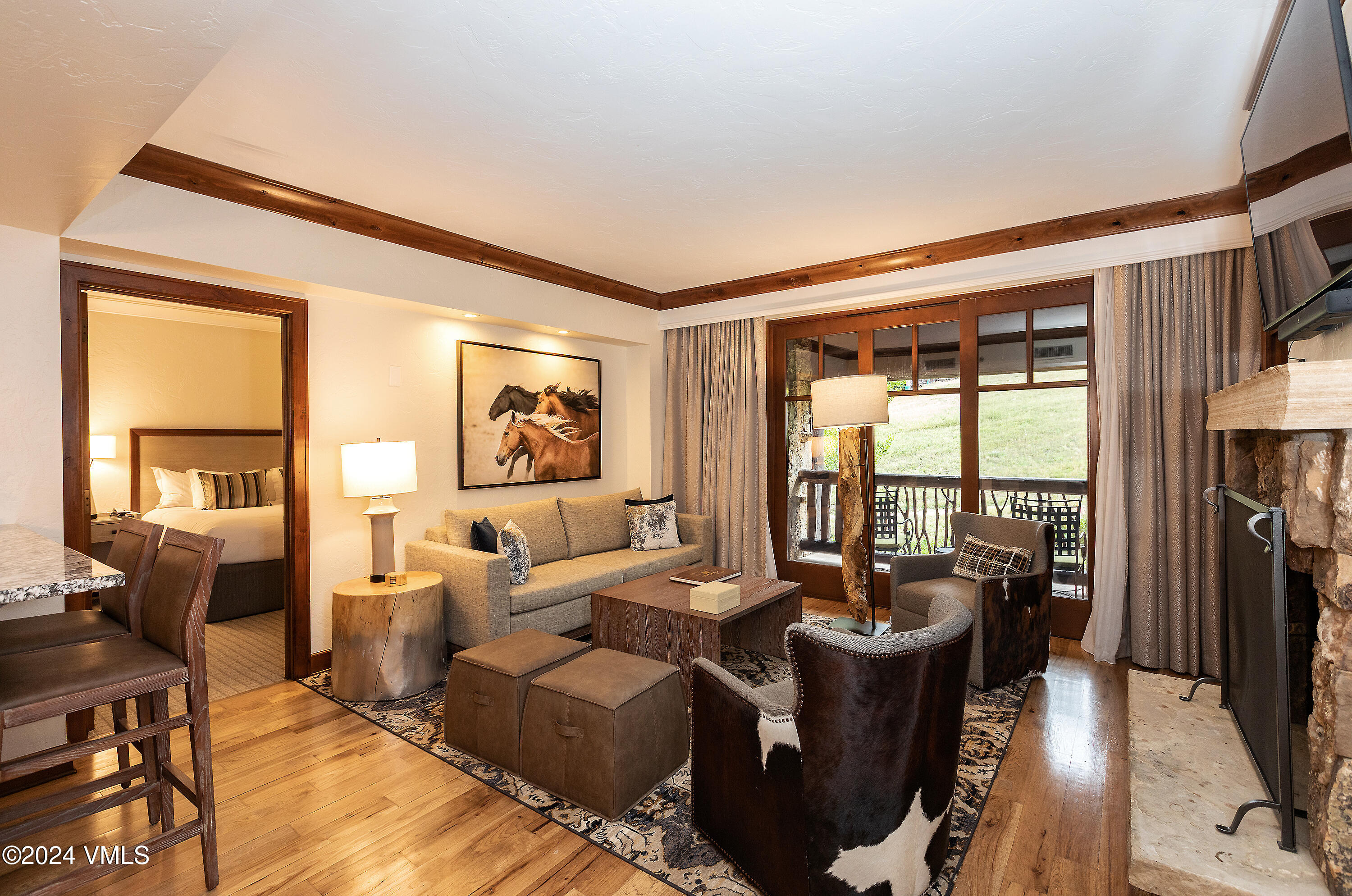 a living room with furniture large windows and a flat screen tv