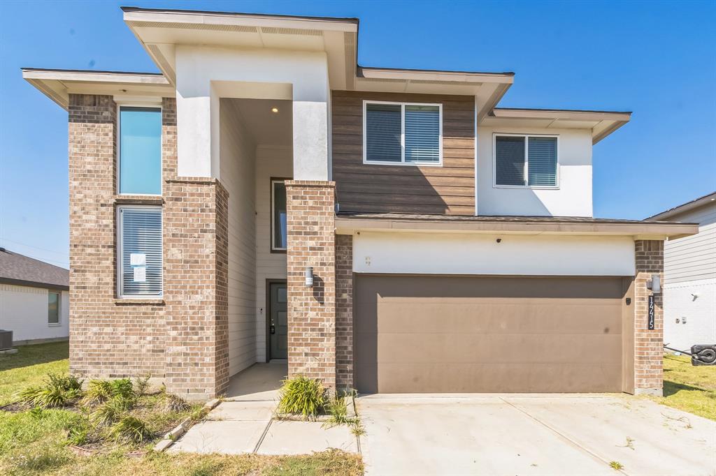 a front view of a house with a garage