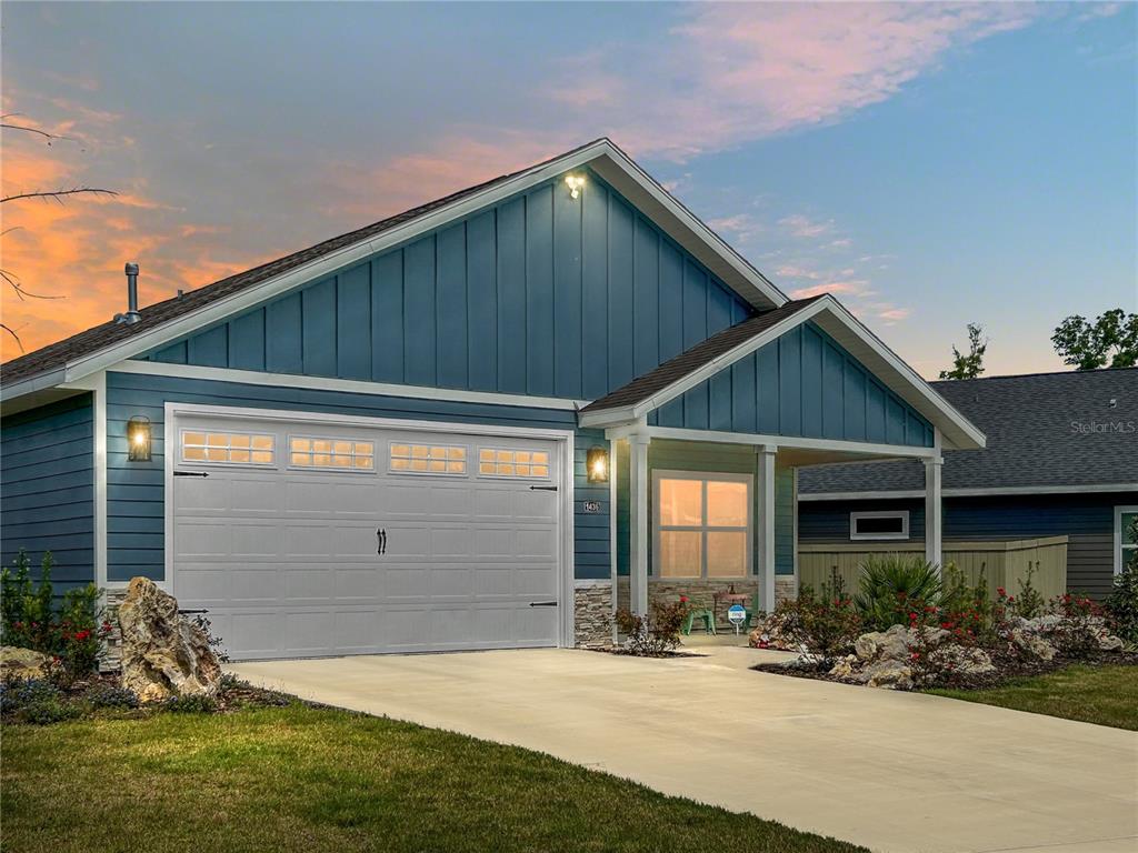 a front view of a house with a yard and outdoor seating