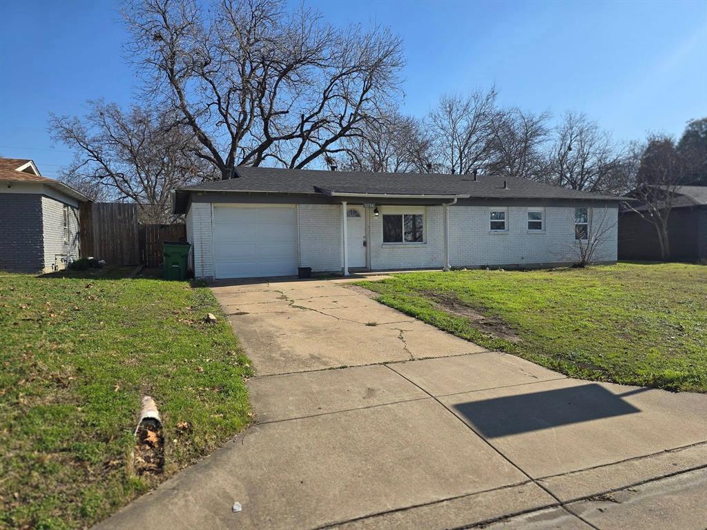 a front view of house with yard and trees around