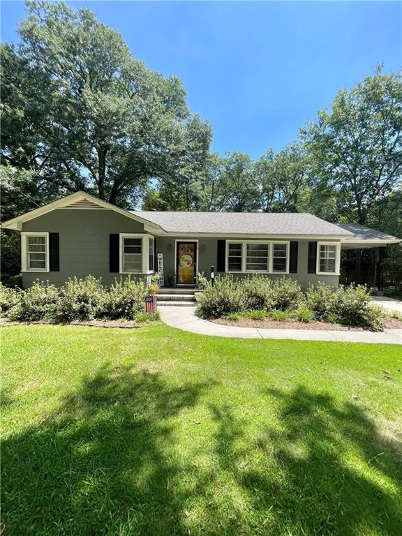 a front view of house with yard and green space