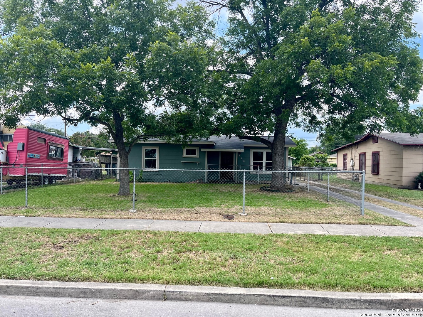 a view of house with a backyard