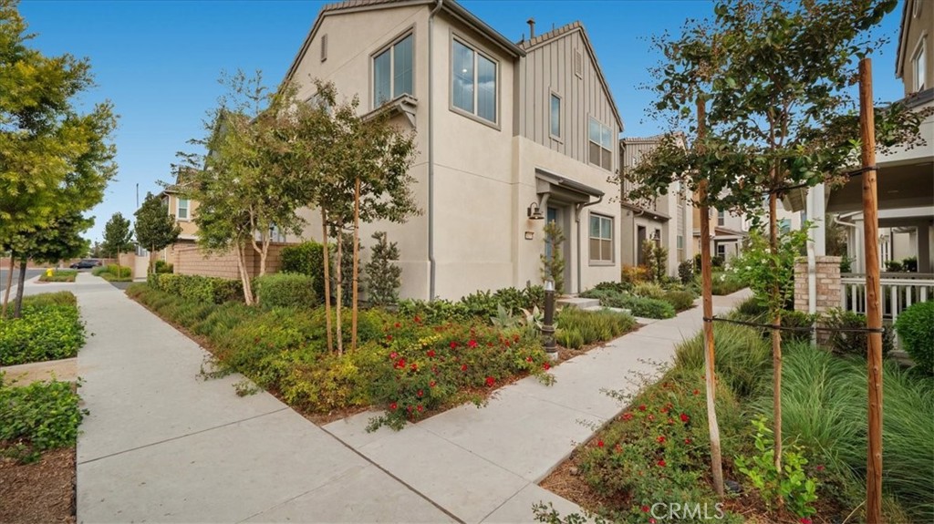 a front view of a house with a garden