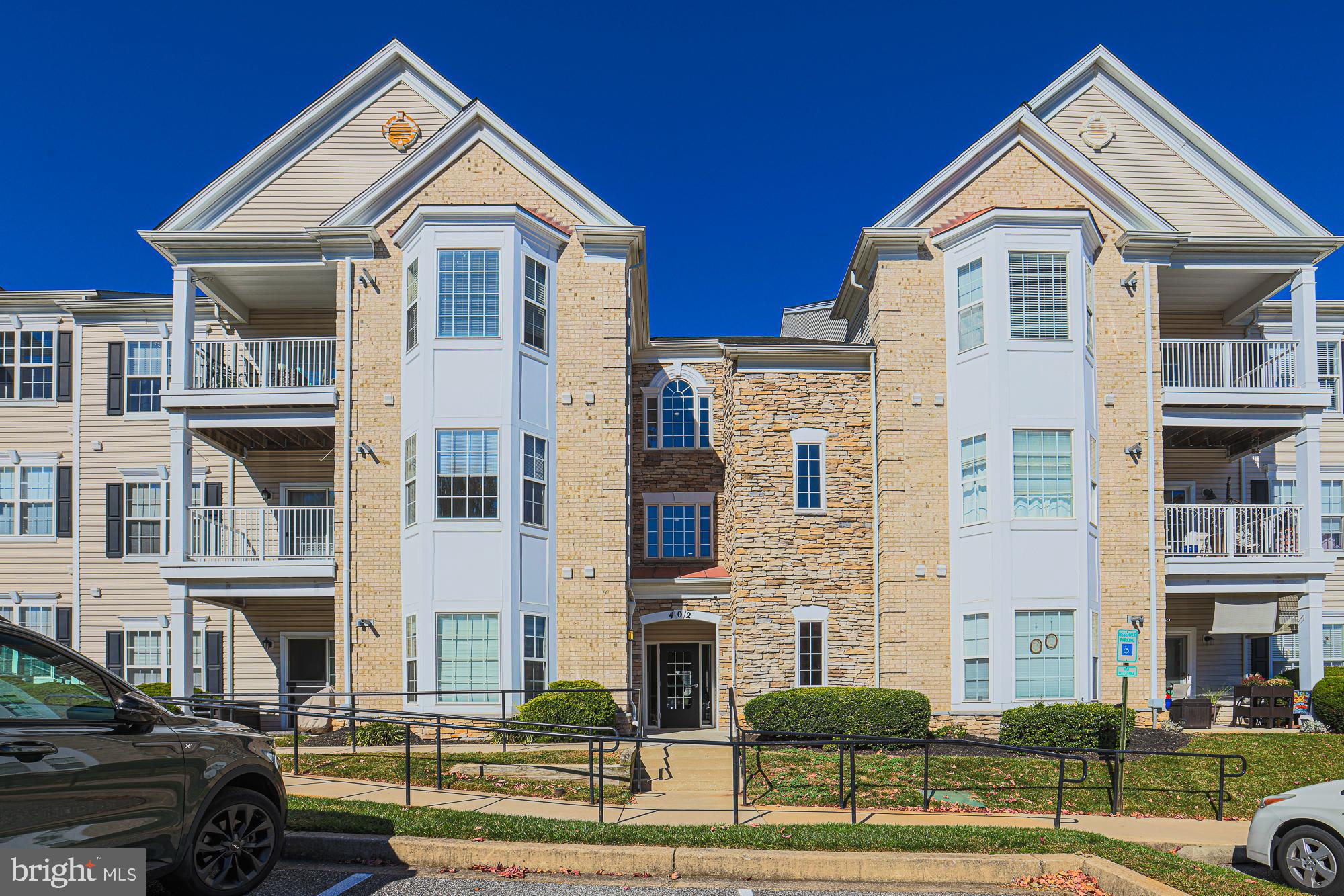 a front view of a residential apartment building with a yard