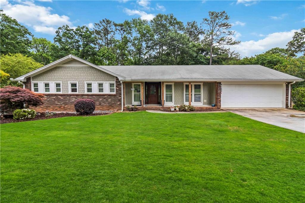 a front view of house with yard and green space