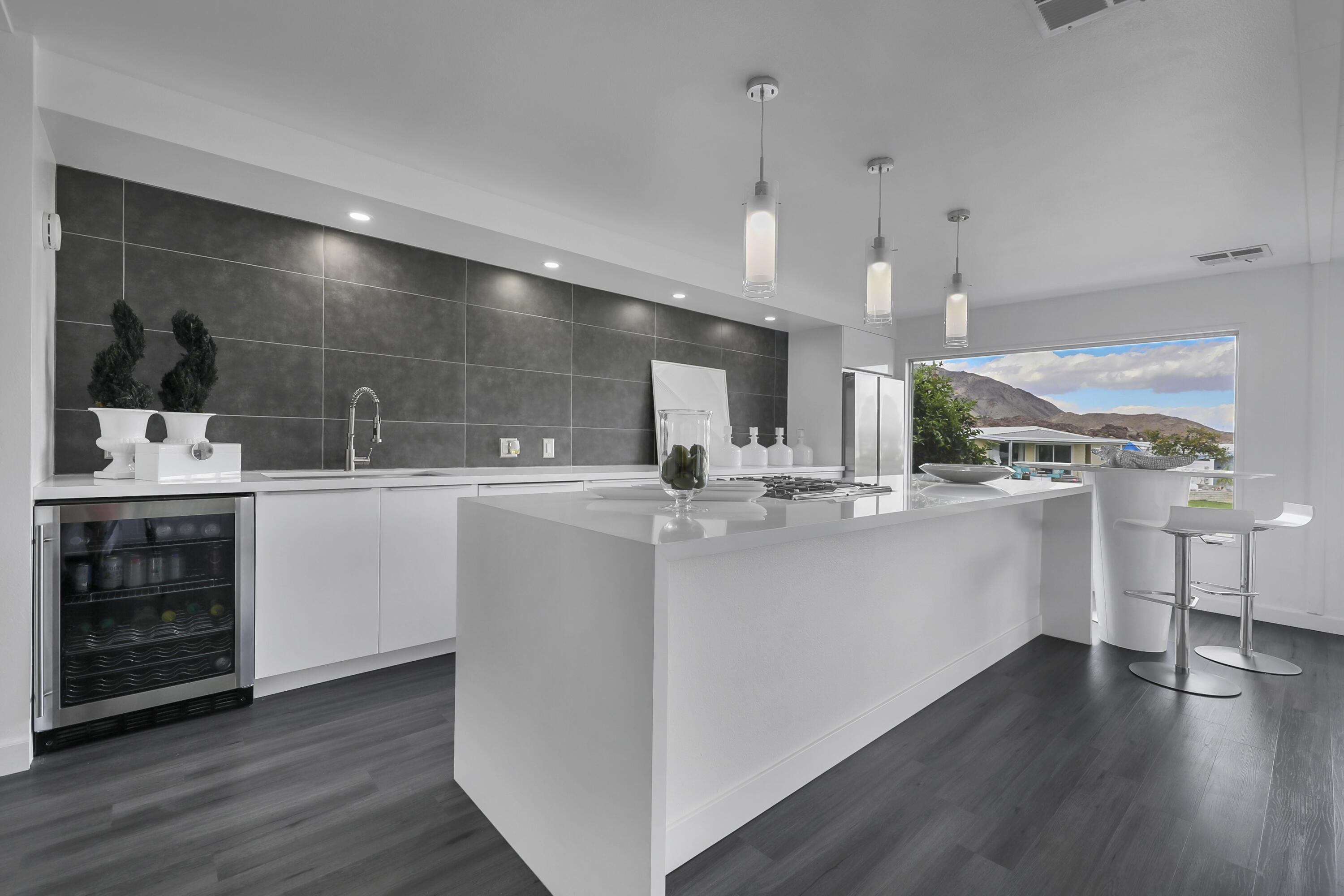 a kitchen with a sink cabinets and wooden floor