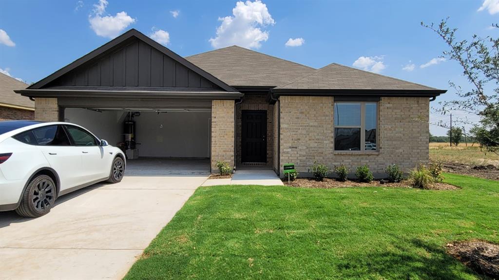 a front view of a house with a yard