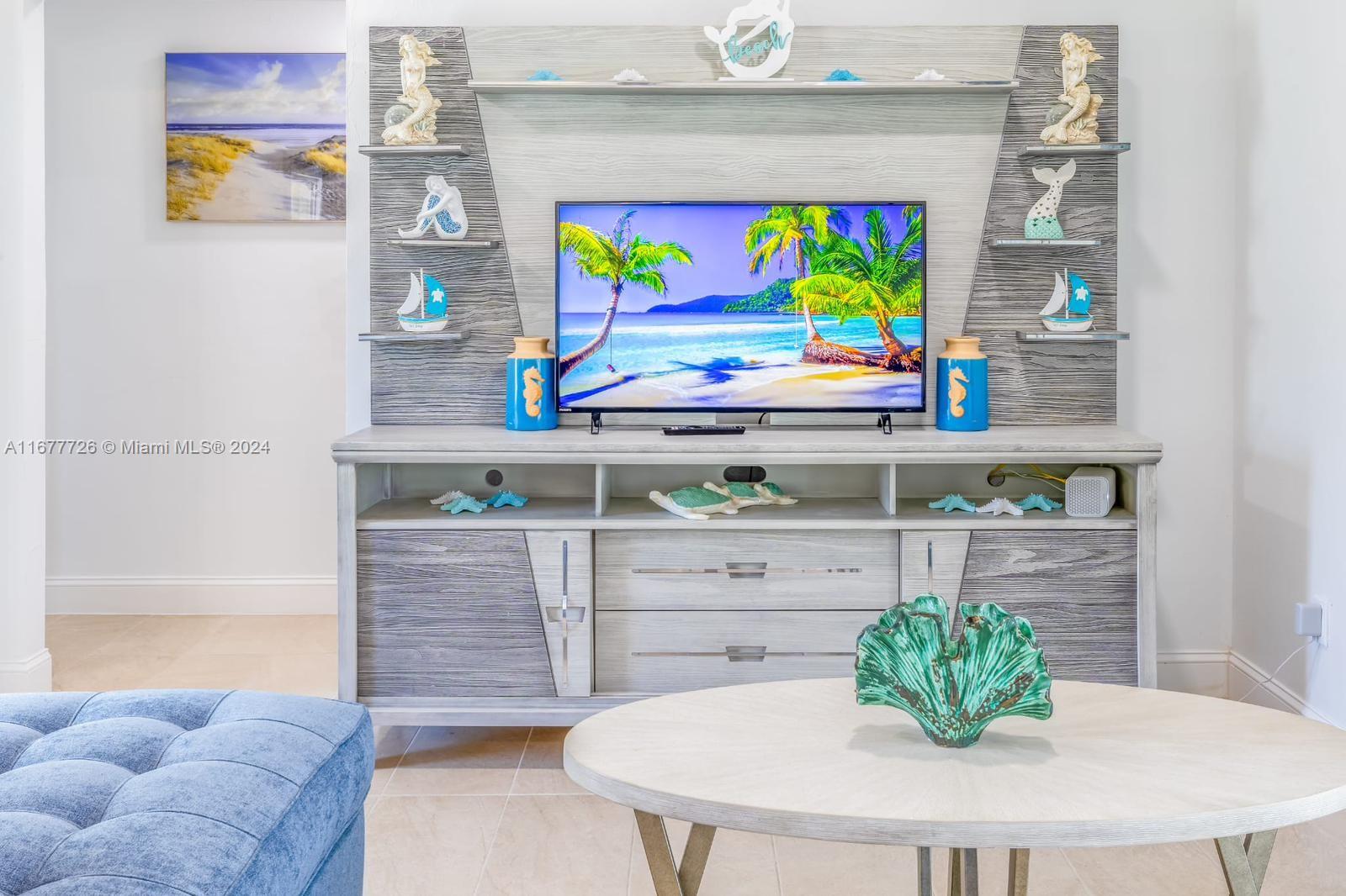 a living room with furniture and painting on the wall