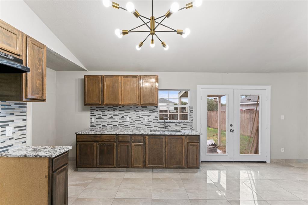 a kitchen with a cabinets and chandelier