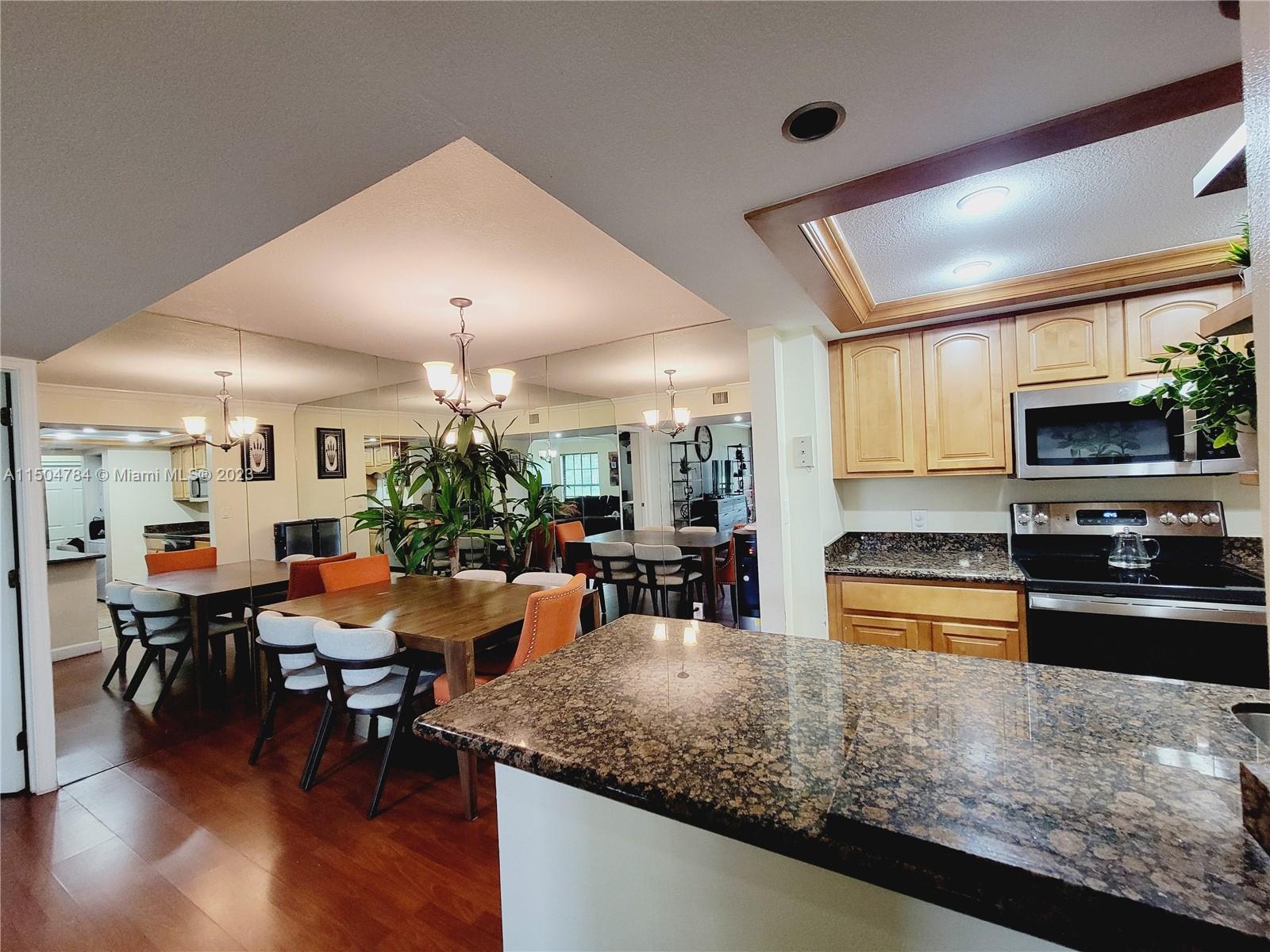 a kitchen with sink refrigerator and cabinets