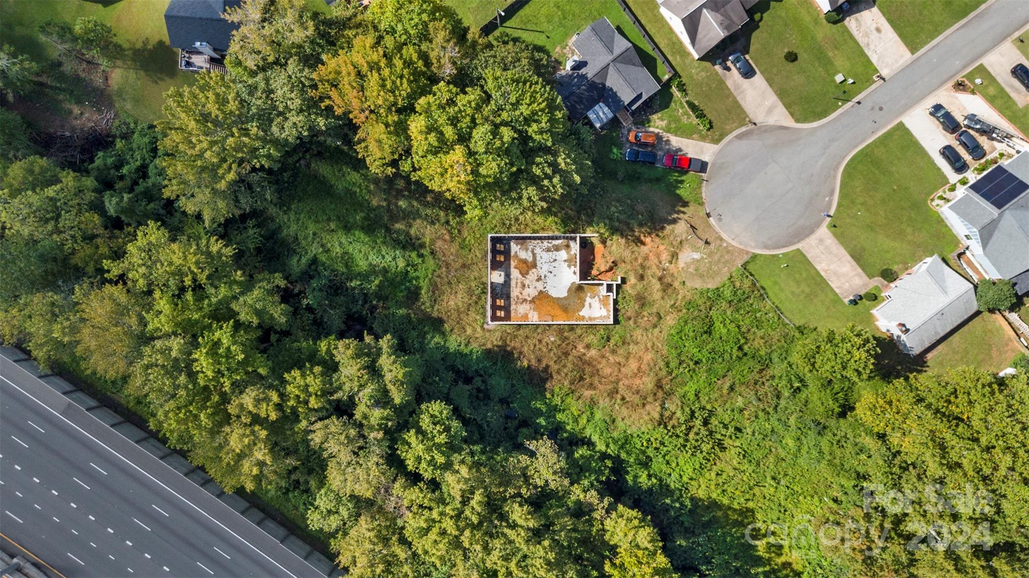 an aerial view of a house with swimming pool and garden