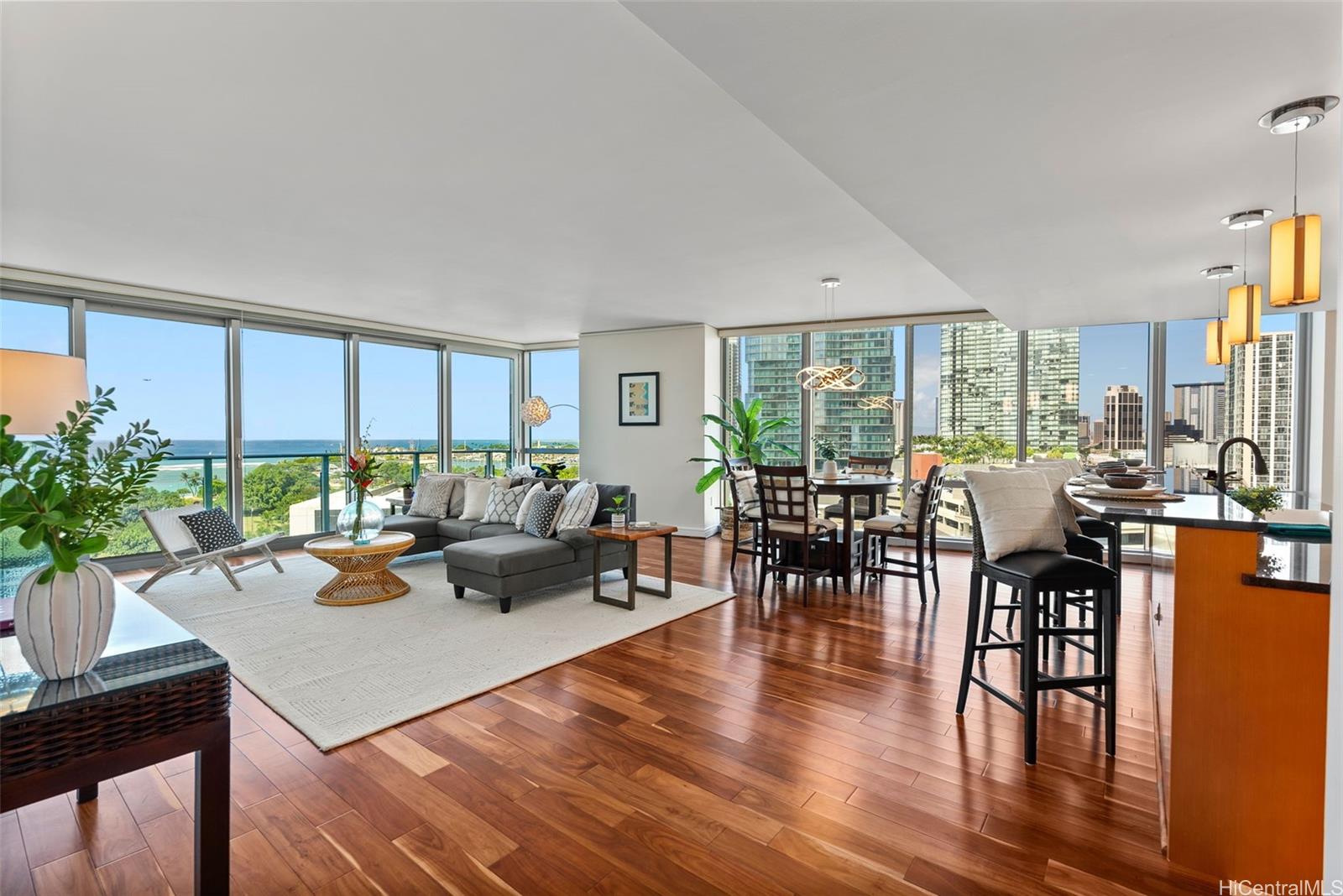 a living room with furniture wooden floor and a large window