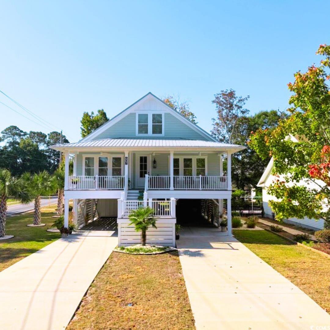 View of front facade featuring covered porch, a fr