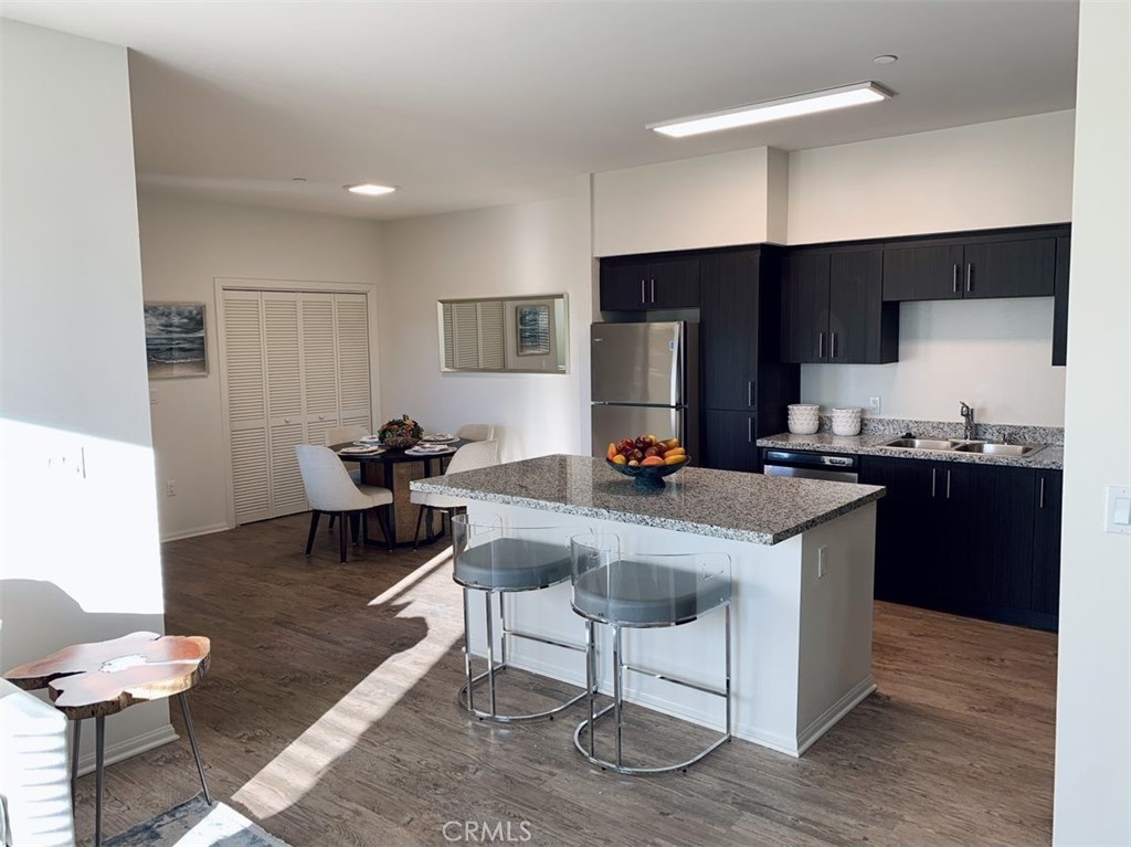 a kitchen with a refrigerator coffee maker on the counter top space