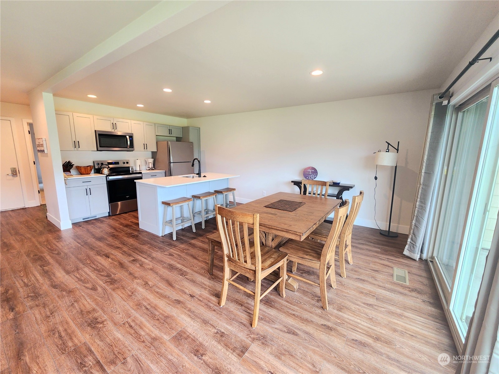 a dining room with furniture and wooden floor