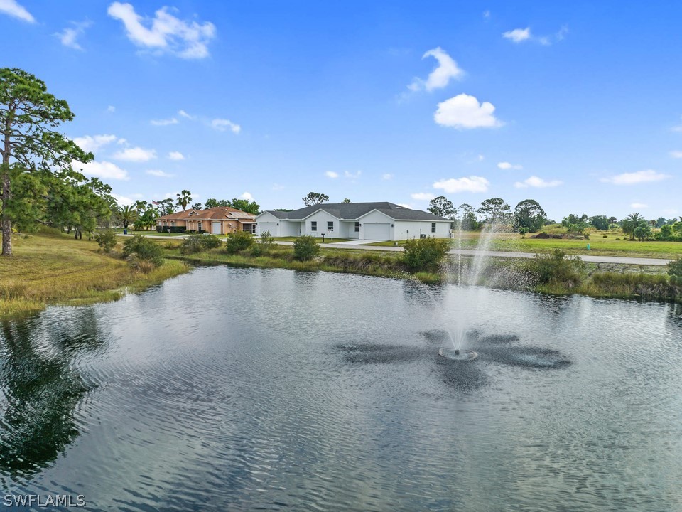 a view of a lake with houses in the back