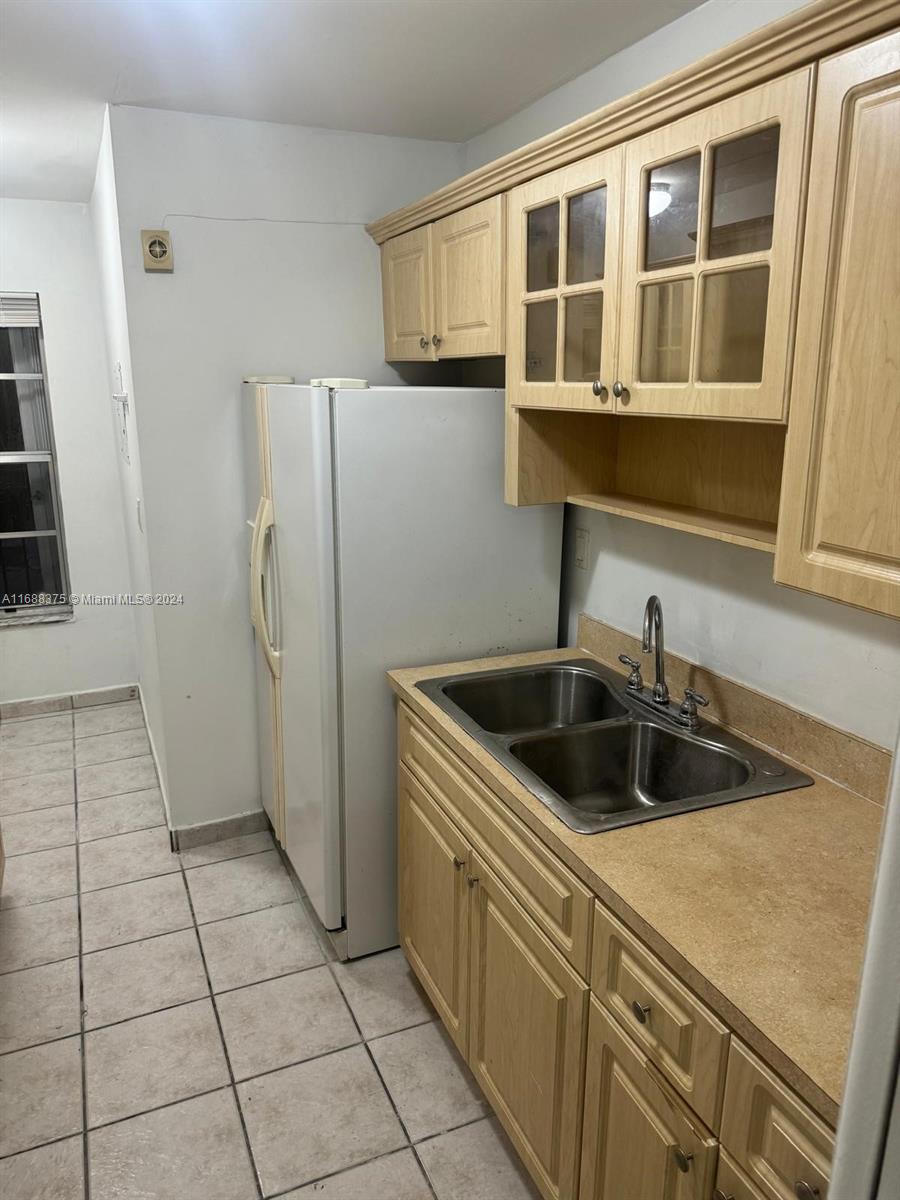 a kitchen with a sink and refrigerator