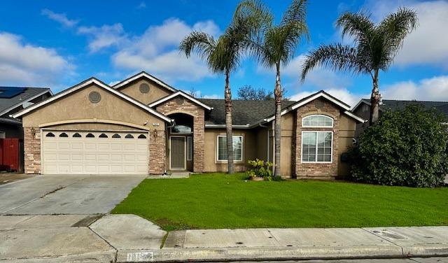 a front view of a house with a garden and yard