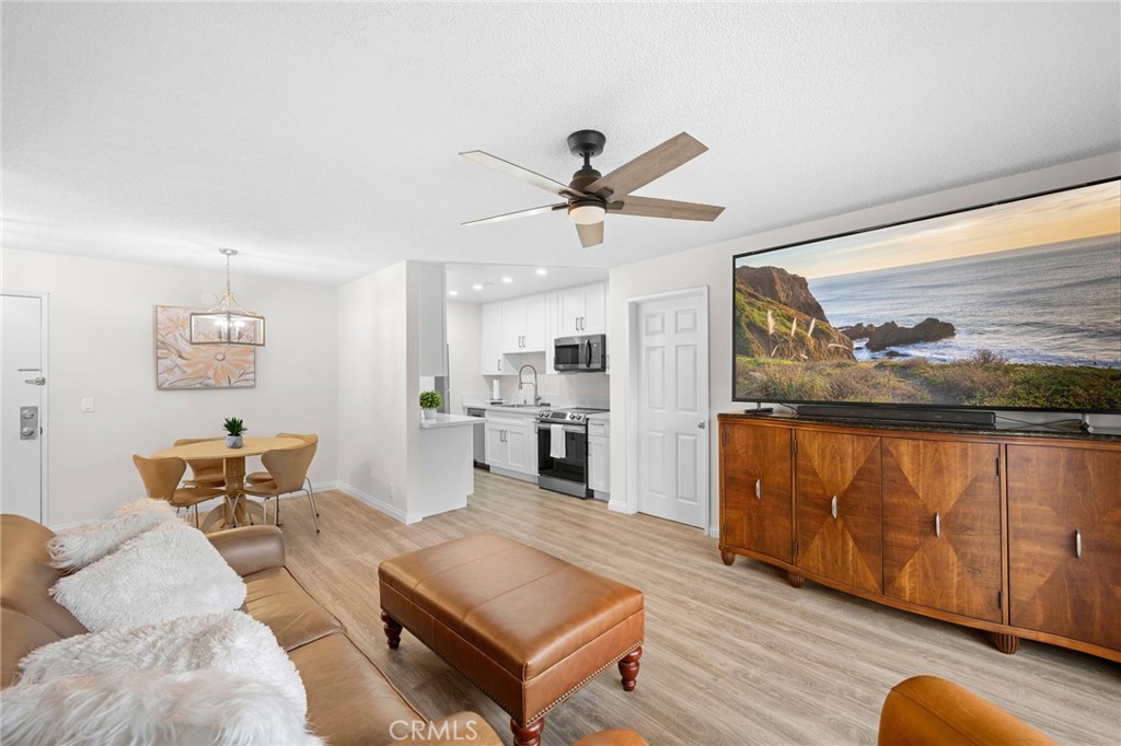 a living room with furniture a rug and a painting on the wall