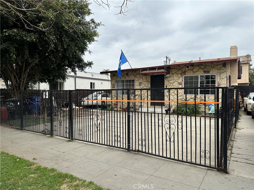 a view of a house with iron fence