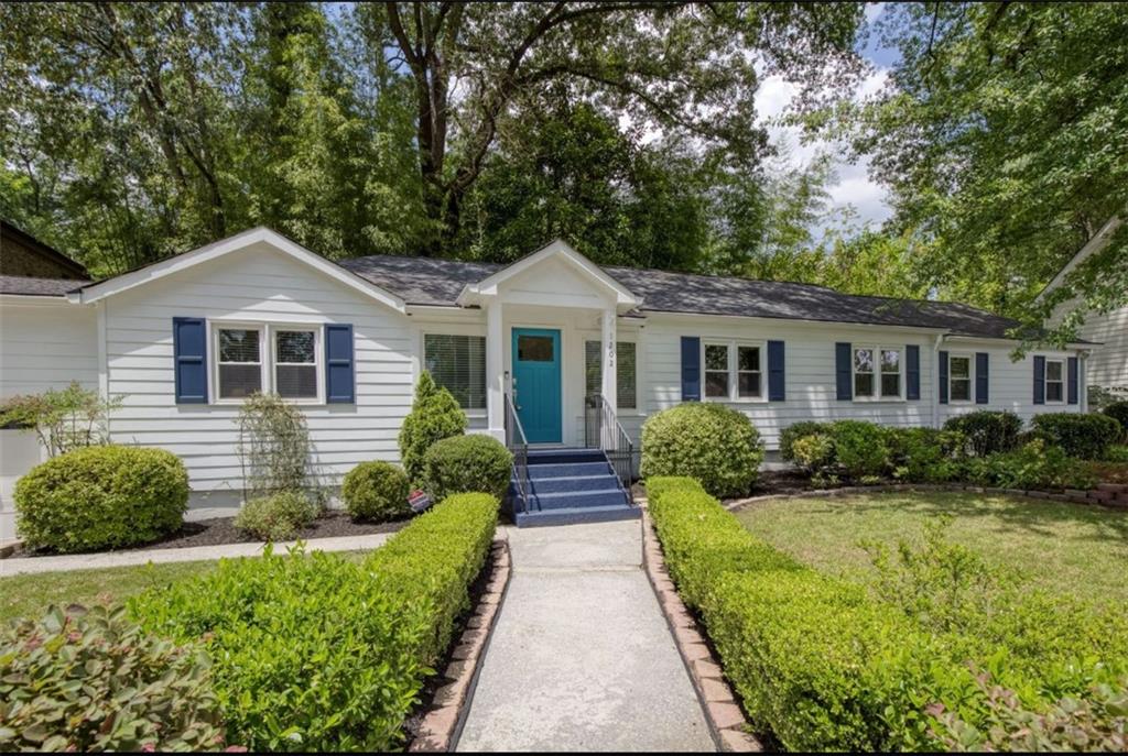 a front view of a house with yard and green space