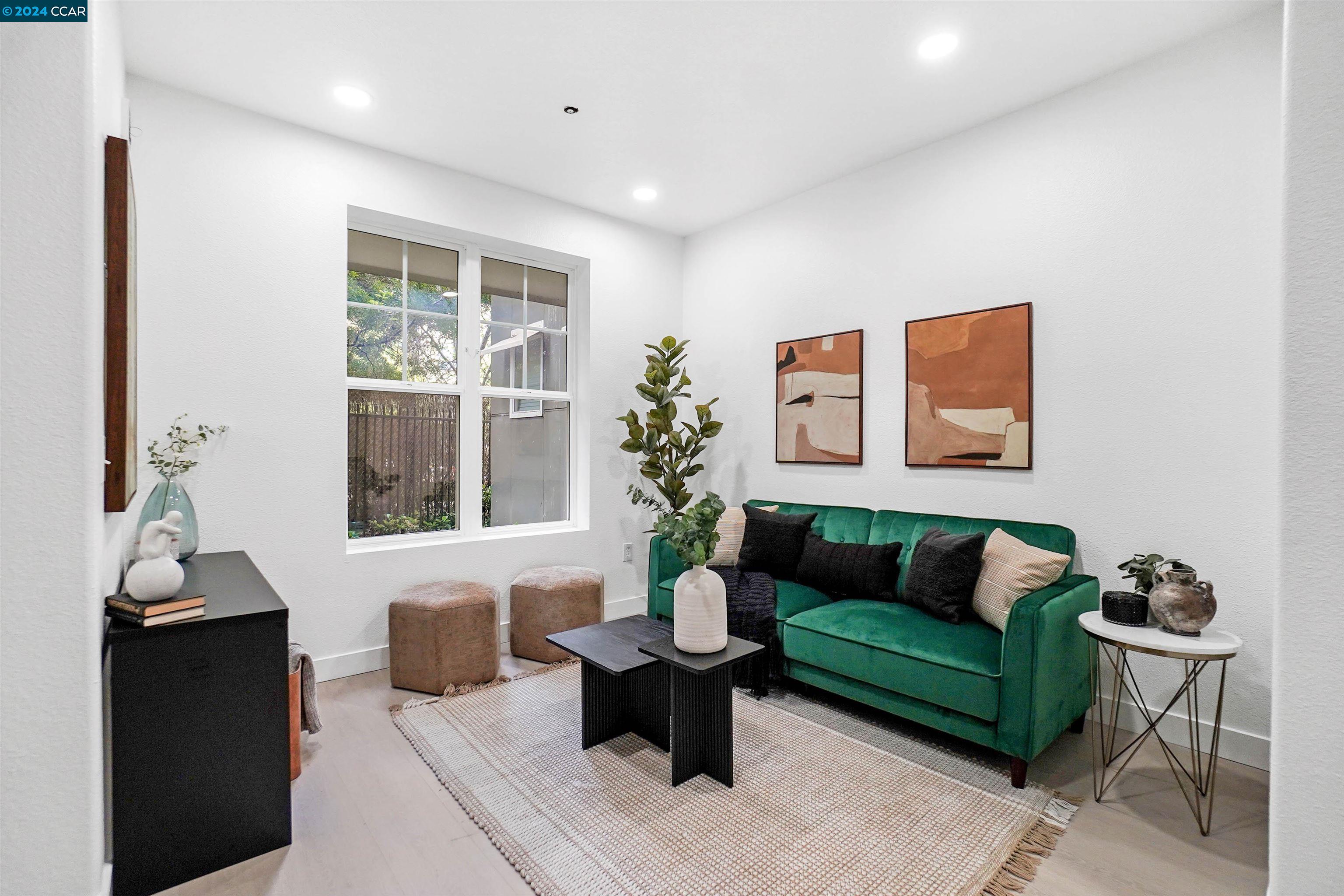 a living room with furniture and a potted plant