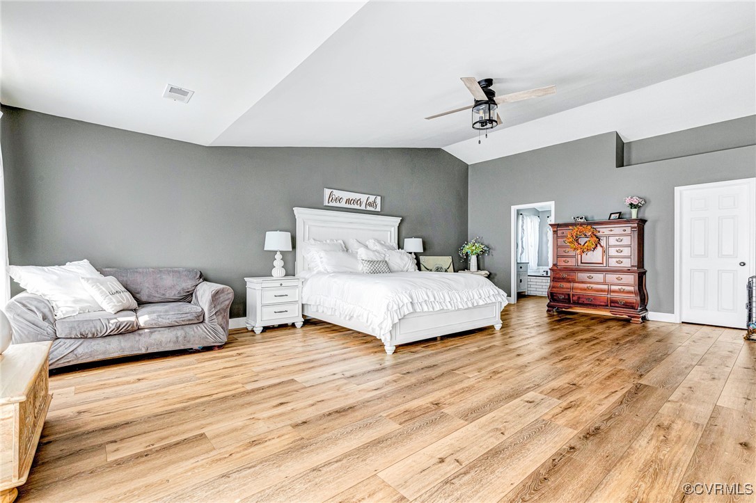 Bedroom featuring light wood-type flooring, vaulte