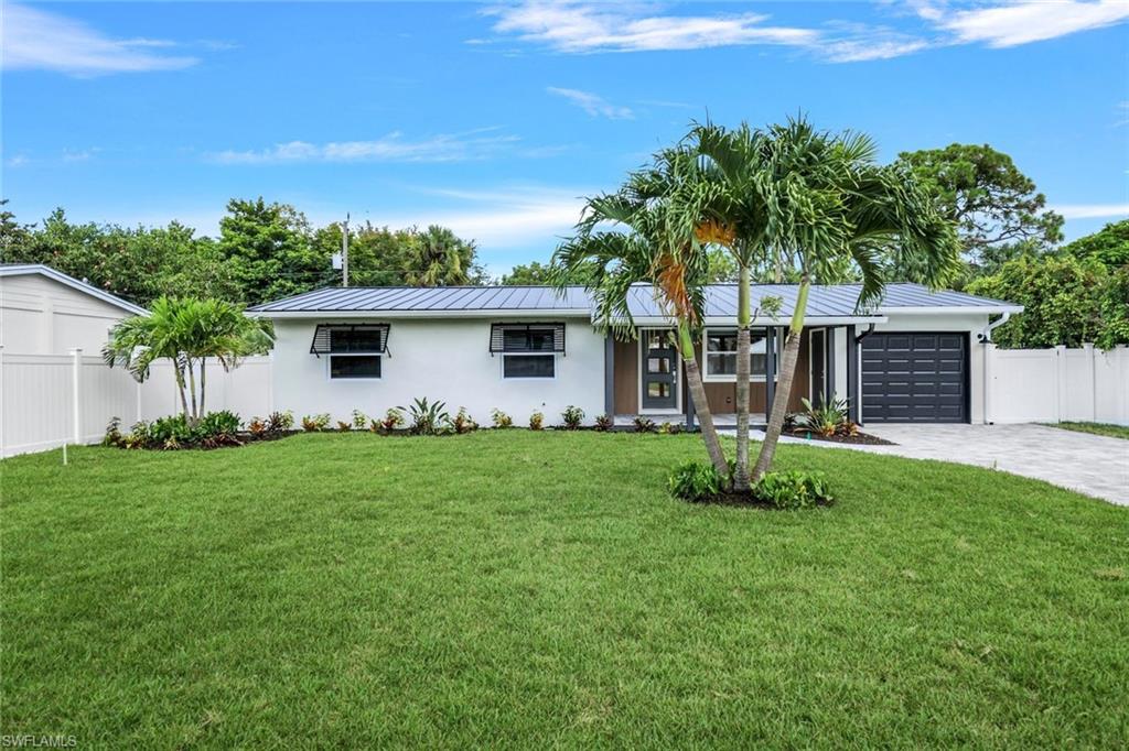 a front view of a house with yard and green space