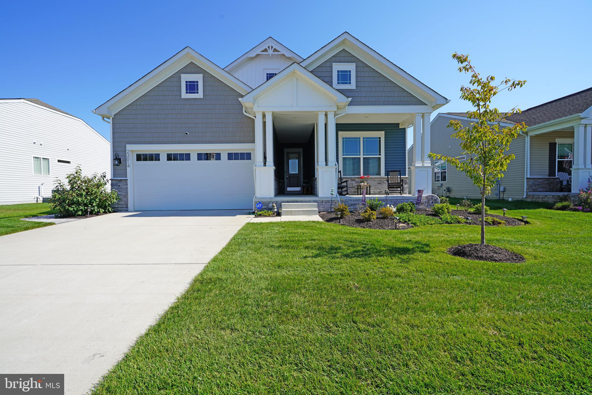 a front view of a house with a yard and porch