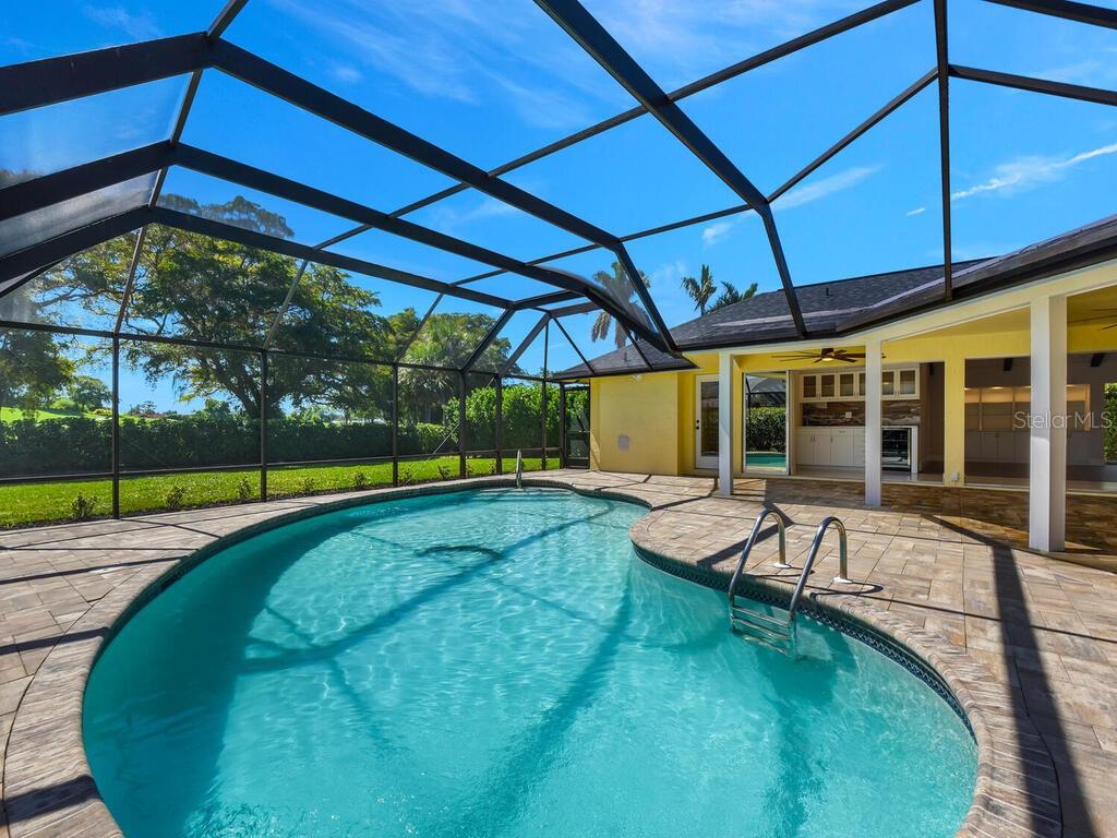 a view of a backyard with swimming pool