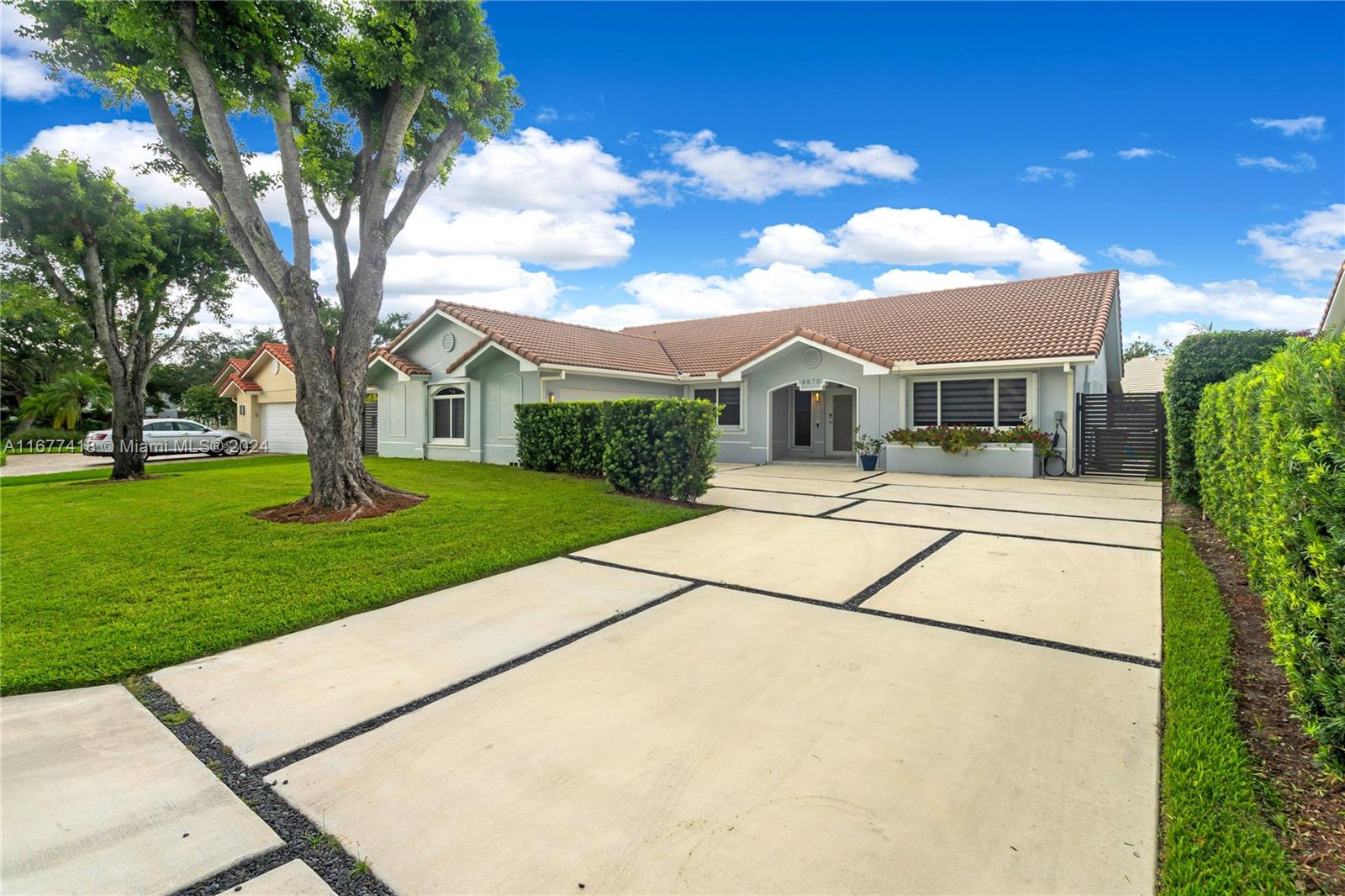 a front view of a house with a garden and yard