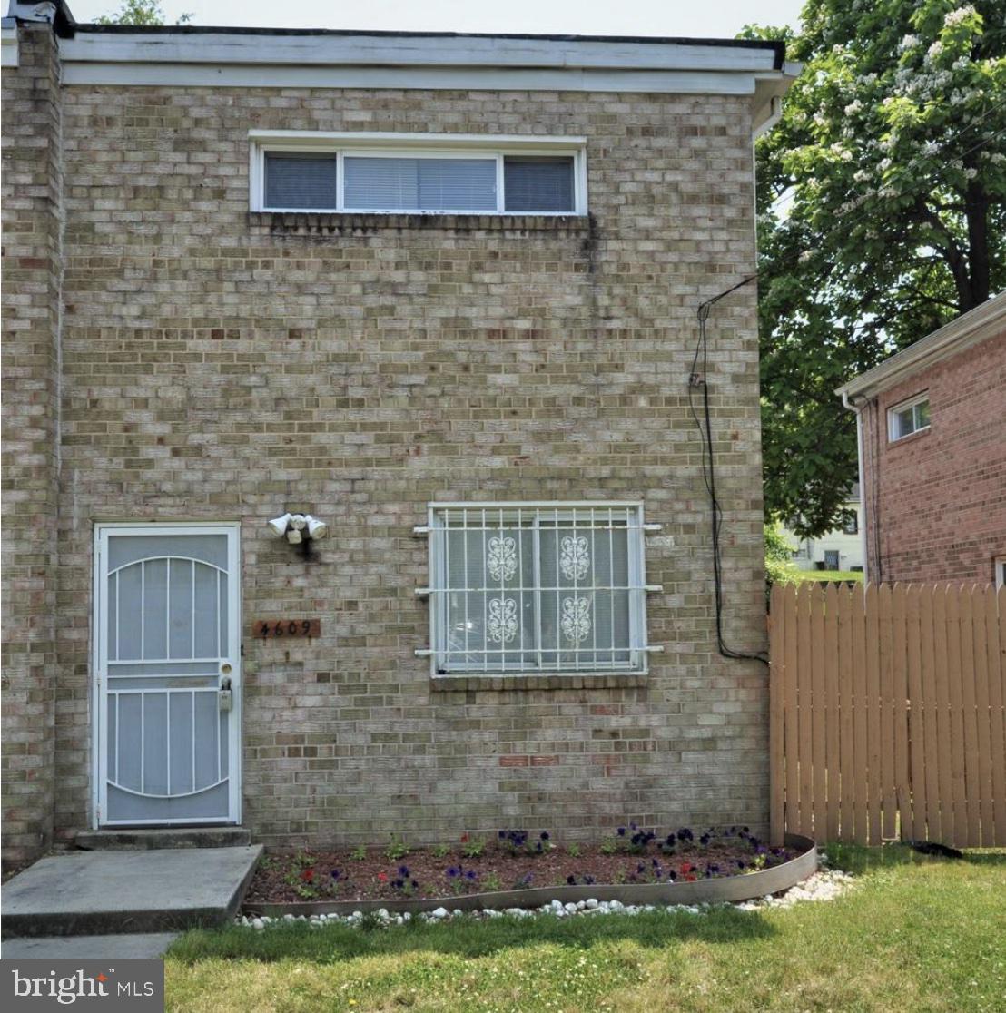 a brick house with a yard in front of it