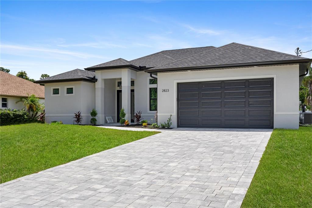 a front view of house with yard and green space