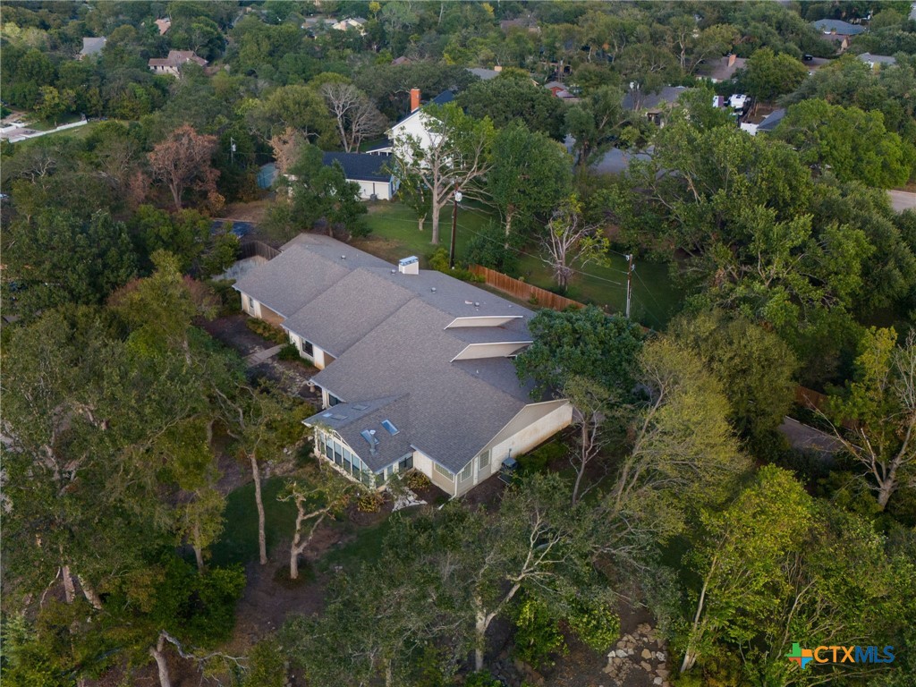 an aerial view of a house with a yard