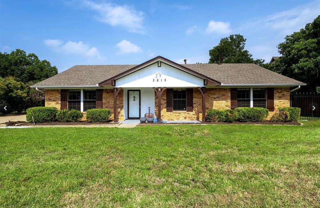 a front view of a house with yard patio and green space