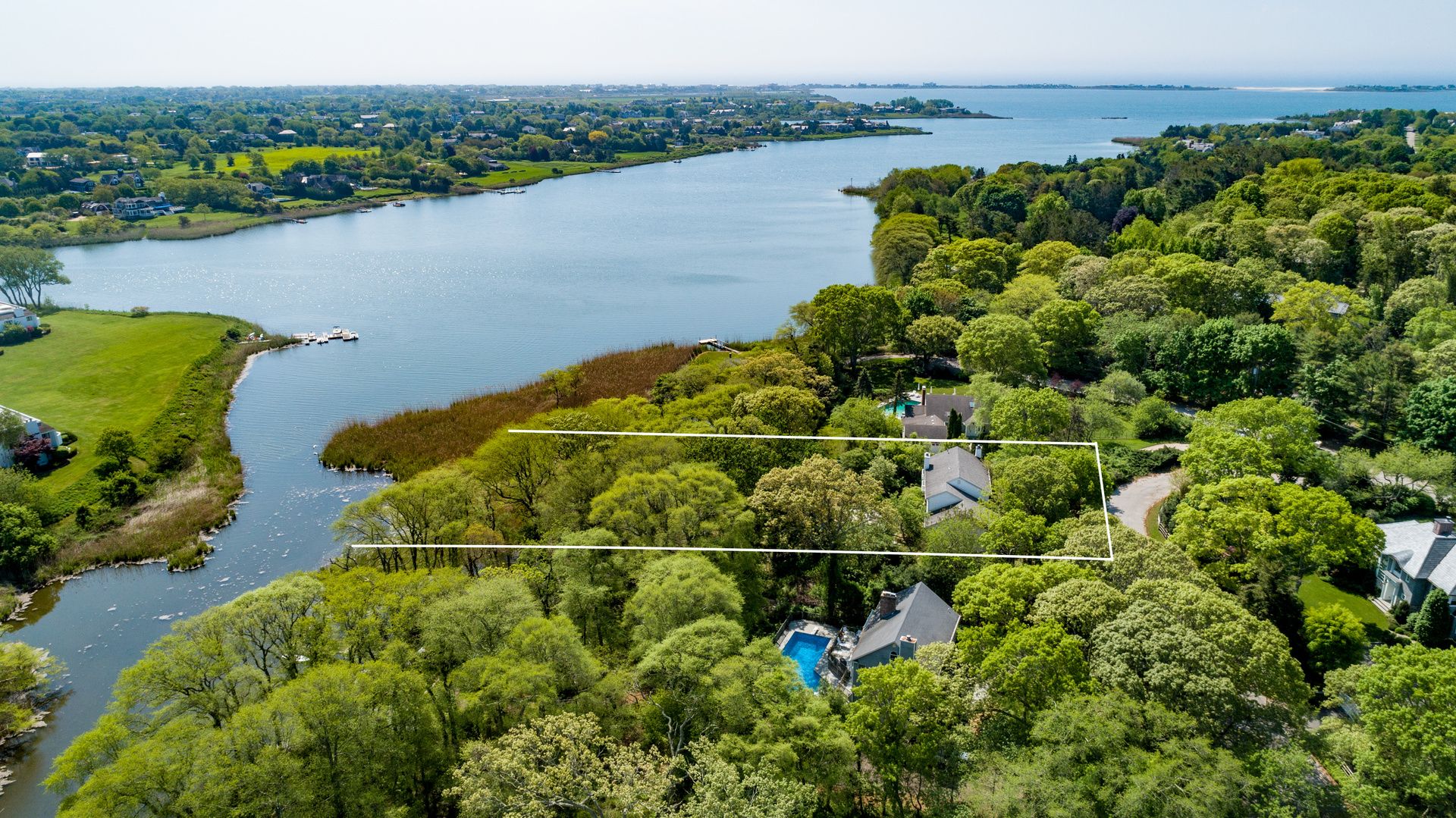 a picture of a lake with a city view