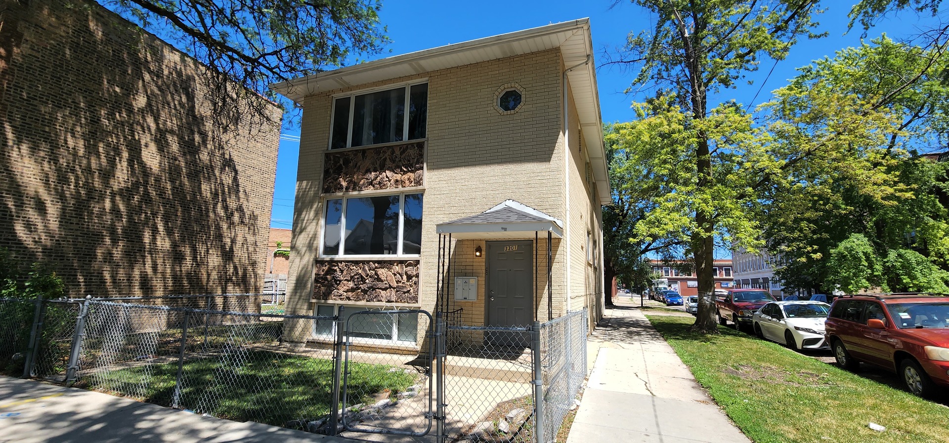 a front view of a house with a garden