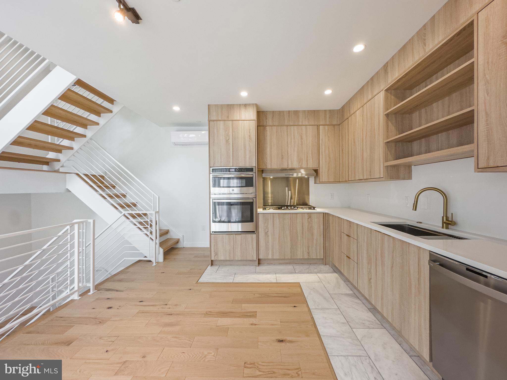 a kitchen with white cabinets and appliances