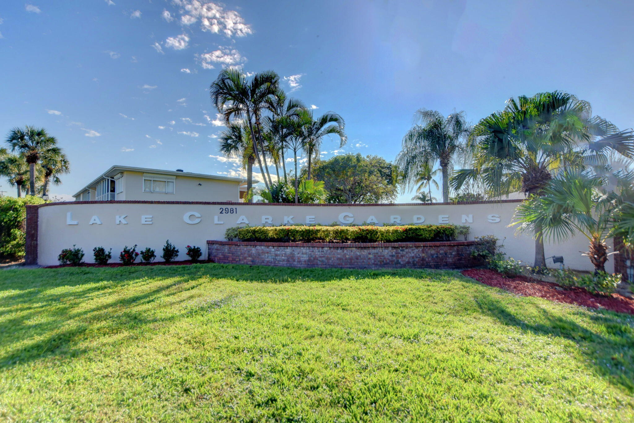 a view of front door of house with yard and swimming pool