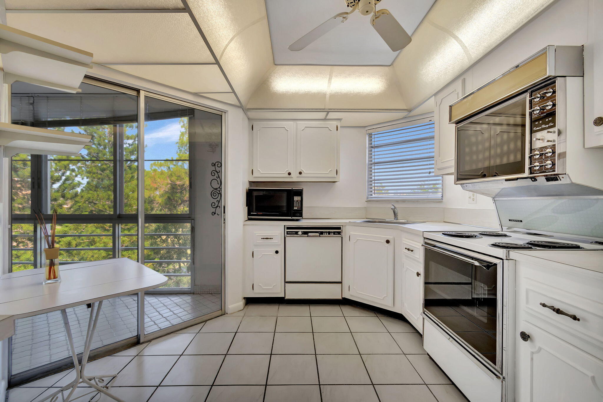 a kitchen with a stove sink and cabinets