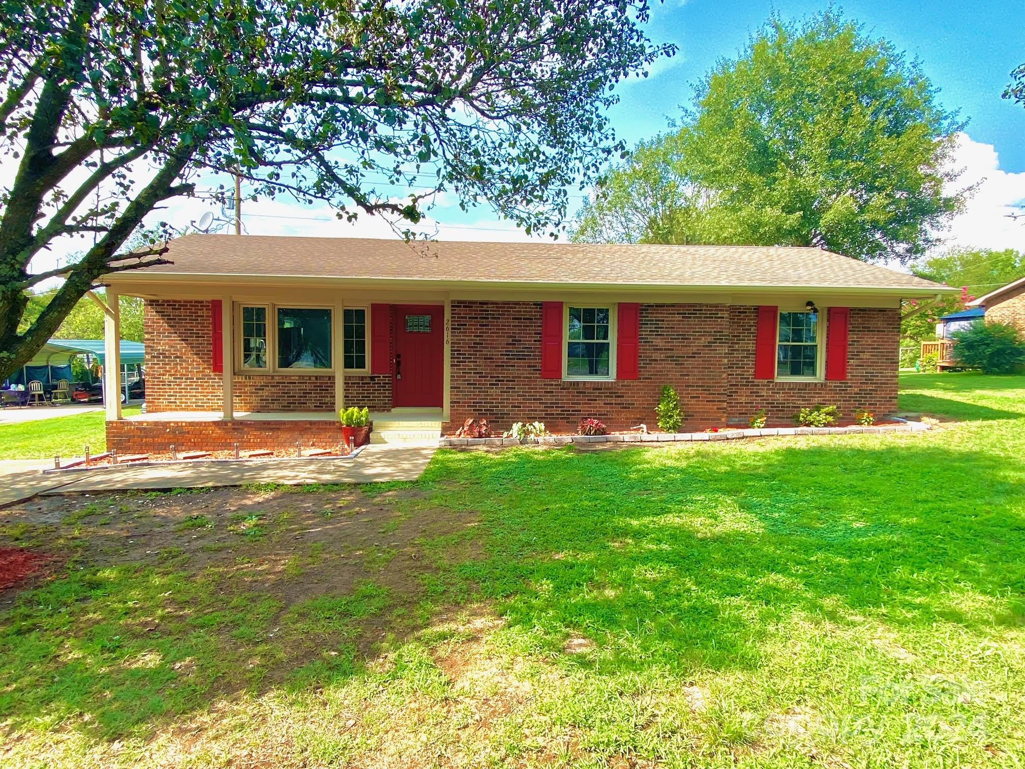 a front view of house with yard and green space