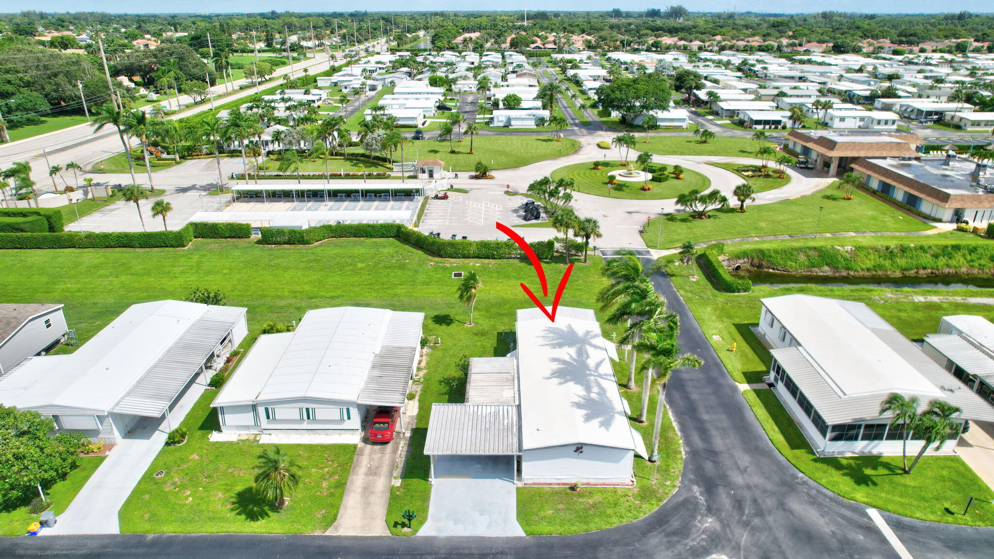 an aerial view of residential houses with outdoor space and parking