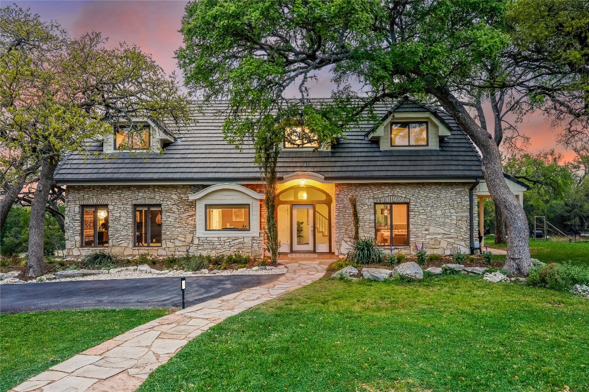 a front view of house with yard and green space